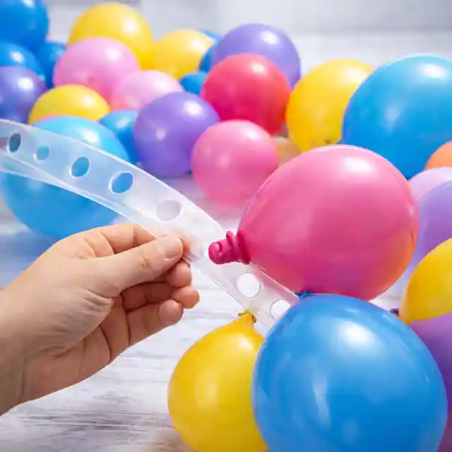 Attaching inflated balloons to decorating strip