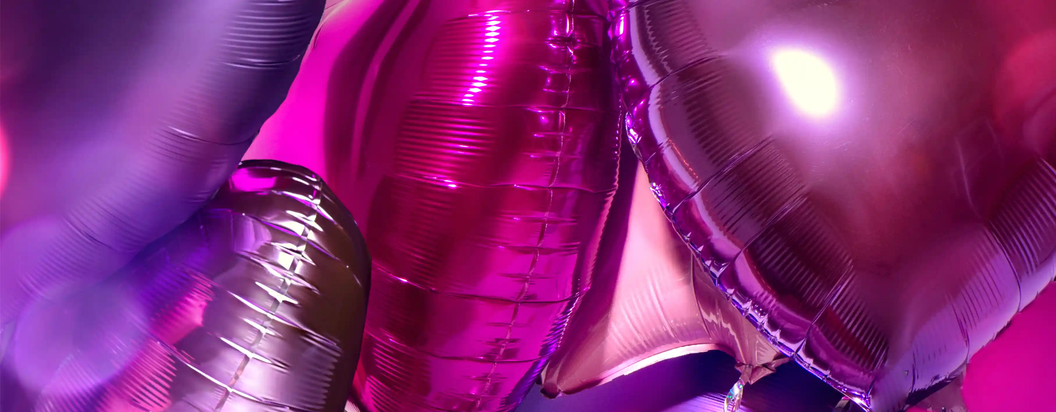 Shiny metallic foil balloons featuring numbers, letters, and decorative shapes