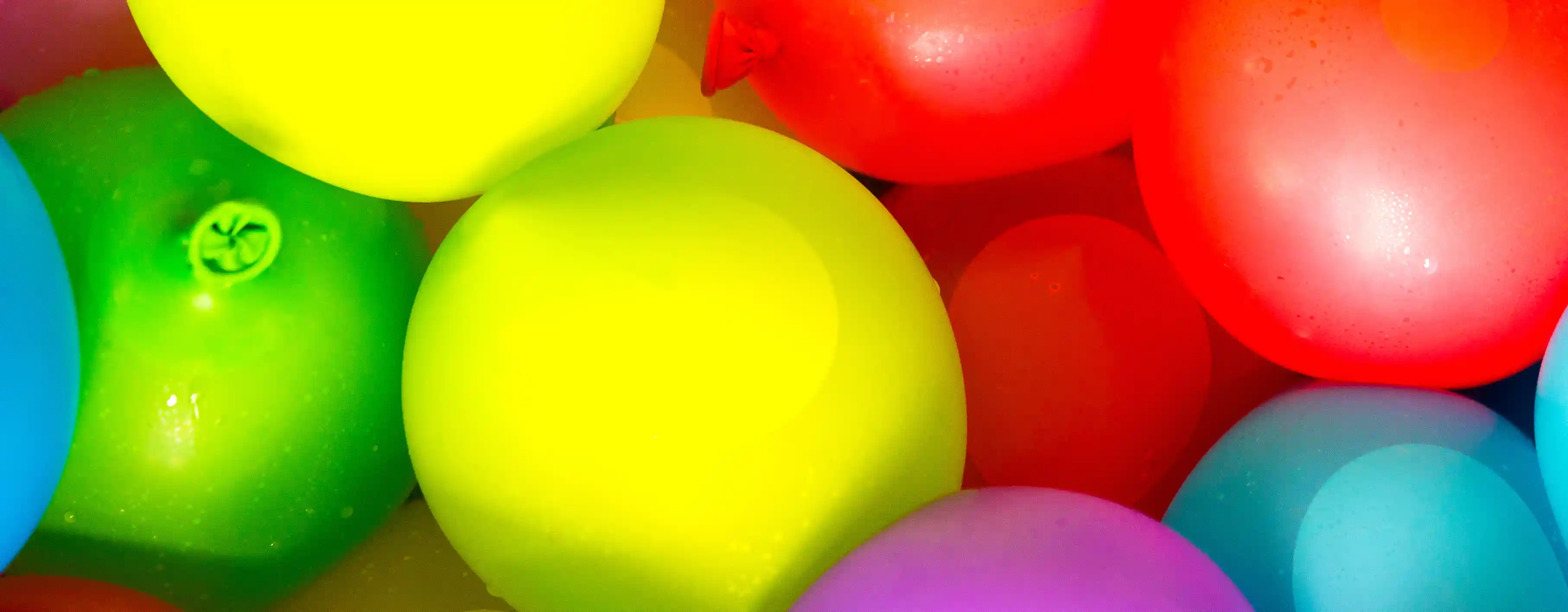 Assorted professional-grade latex balloons in vibrant solid colors