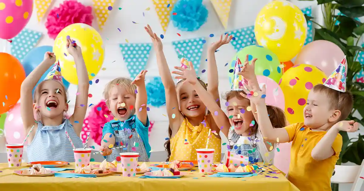Colorful Prima balloon arch and bouquets decorating a birthday party celebration