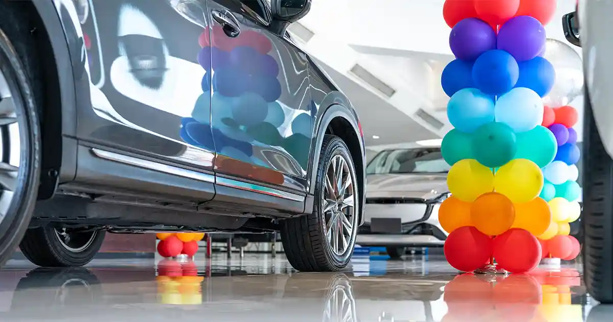 Eye-catching Prima balloon display at an automotive dealership with bright colors